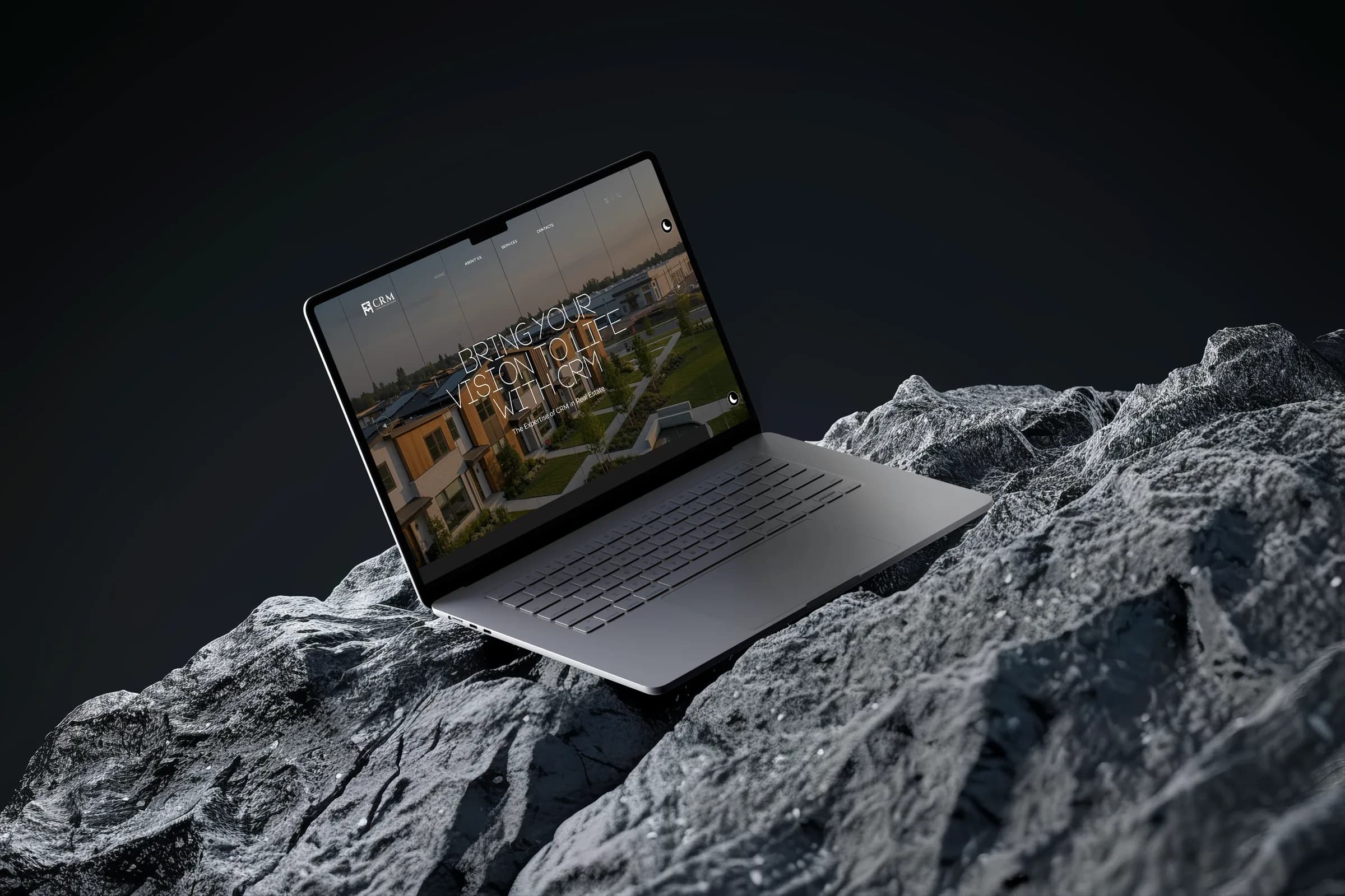 CRM Construction and Development site on a laptop on grey rock against a dark sky